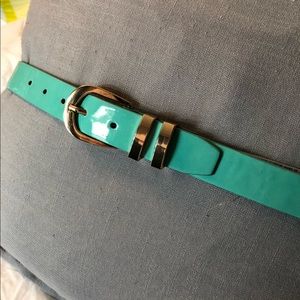 Aqua colored belt with gold buckle.